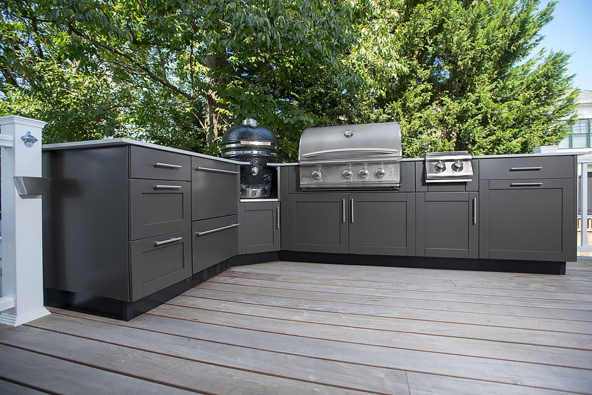 outdoor kitchen with grill and grey cabinets