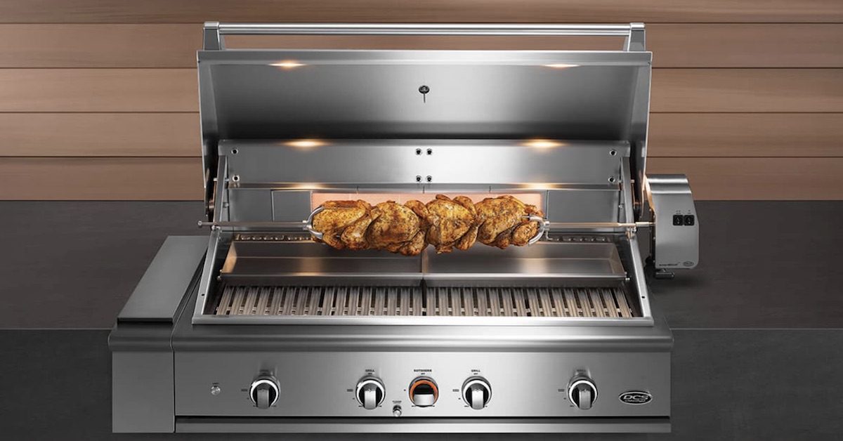 open DCS grill with chicken on rotisserie