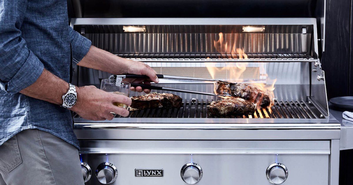 man grilling steak