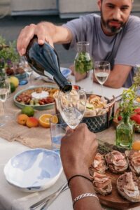 wine being poured while dining outdoors