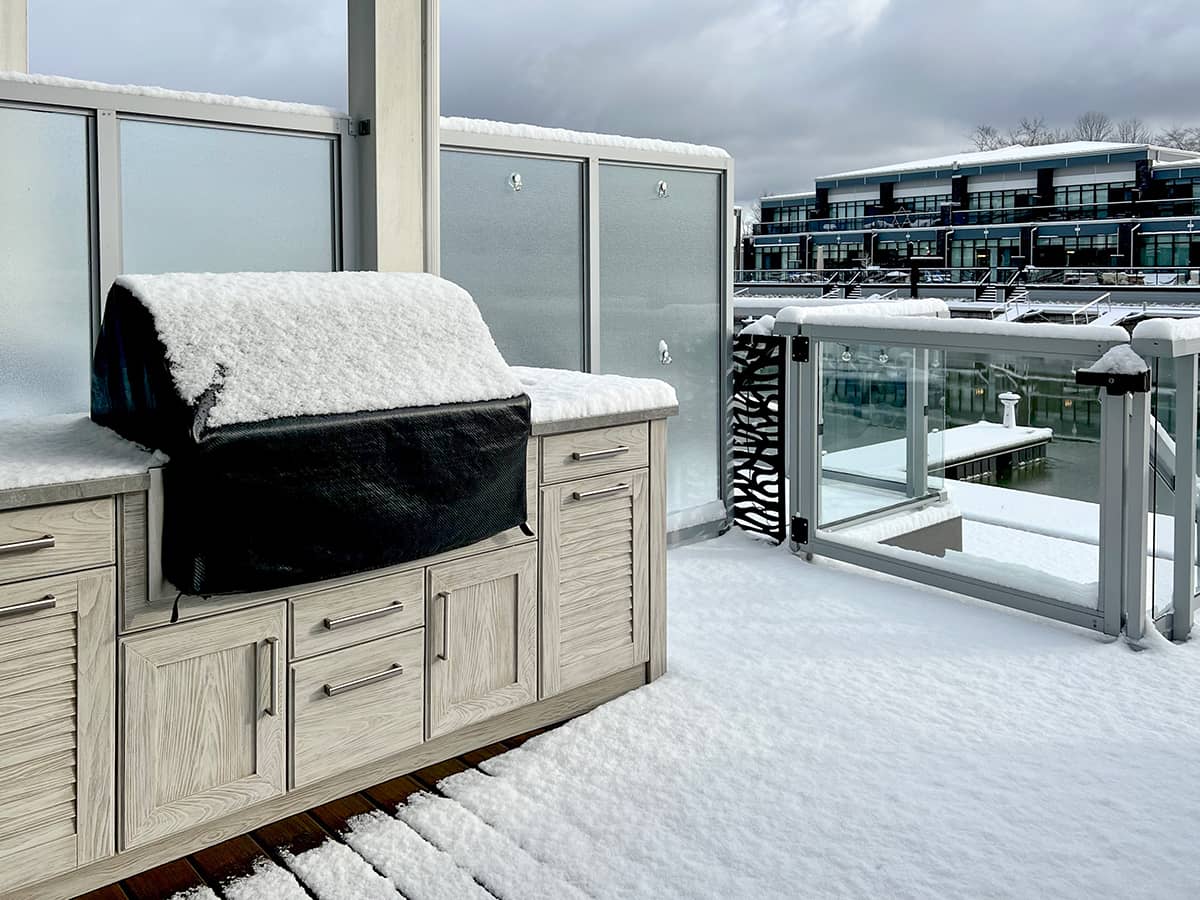 Outdoor grill and cabinetry on deck in winter