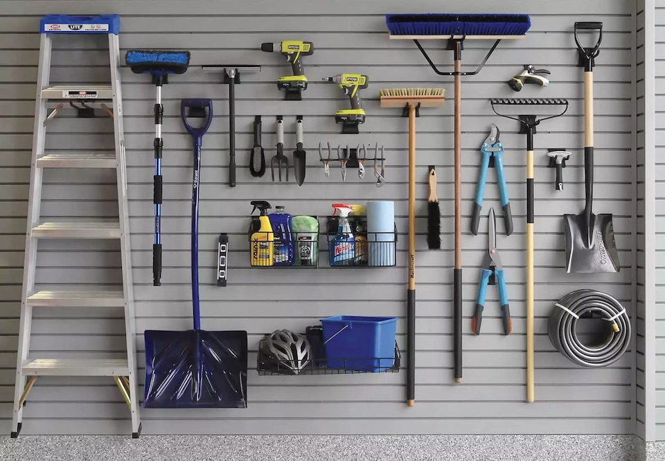 yard tools on garage wall