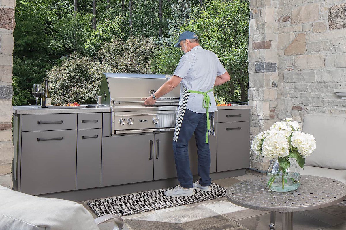 man using outdoor kitchen