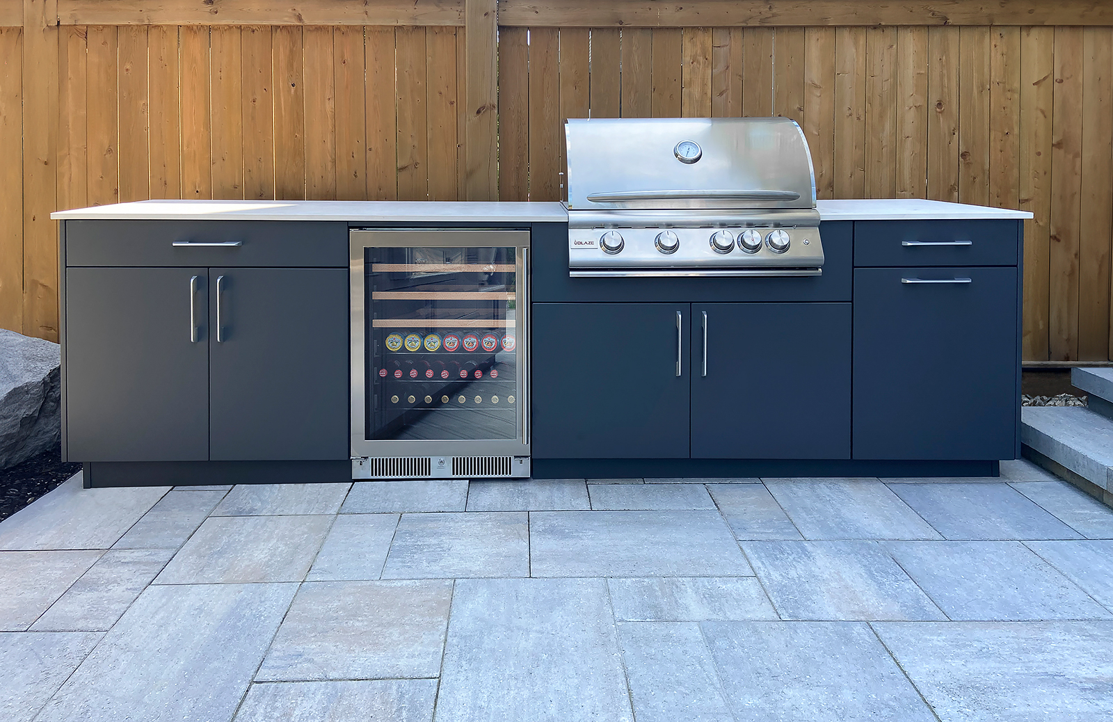 blaze grill, blue cabinetry and bar fridge