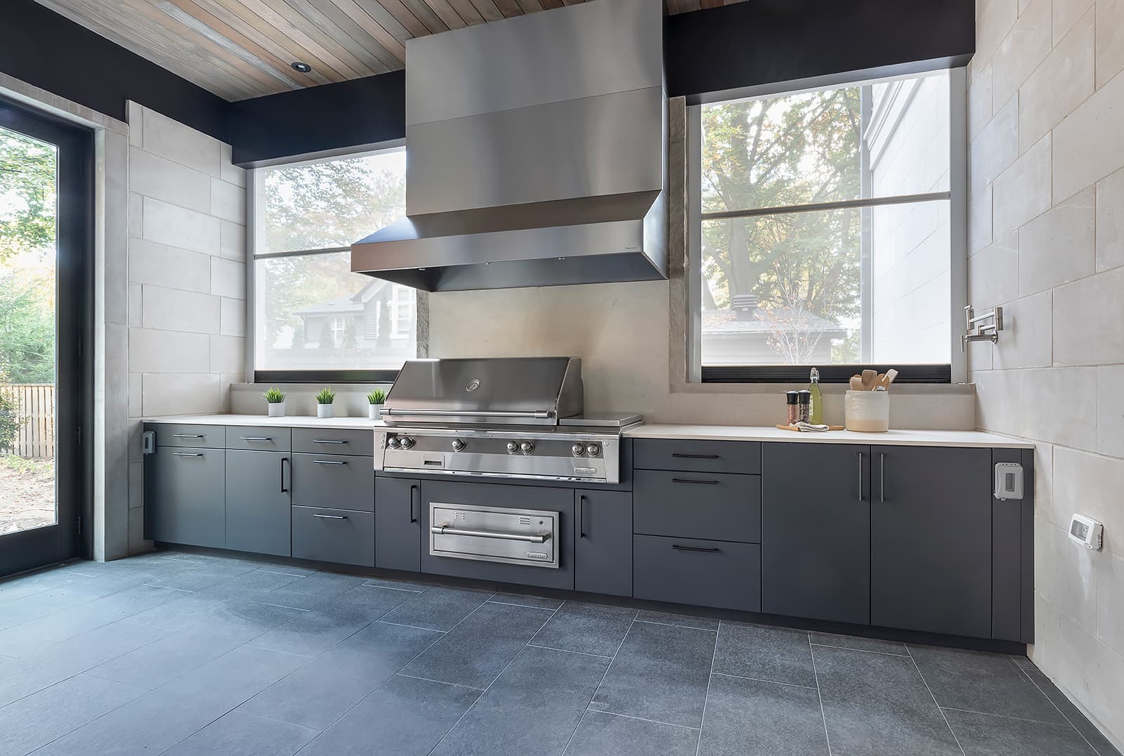 wide shot of grill and cabinetry and expansive countertops
