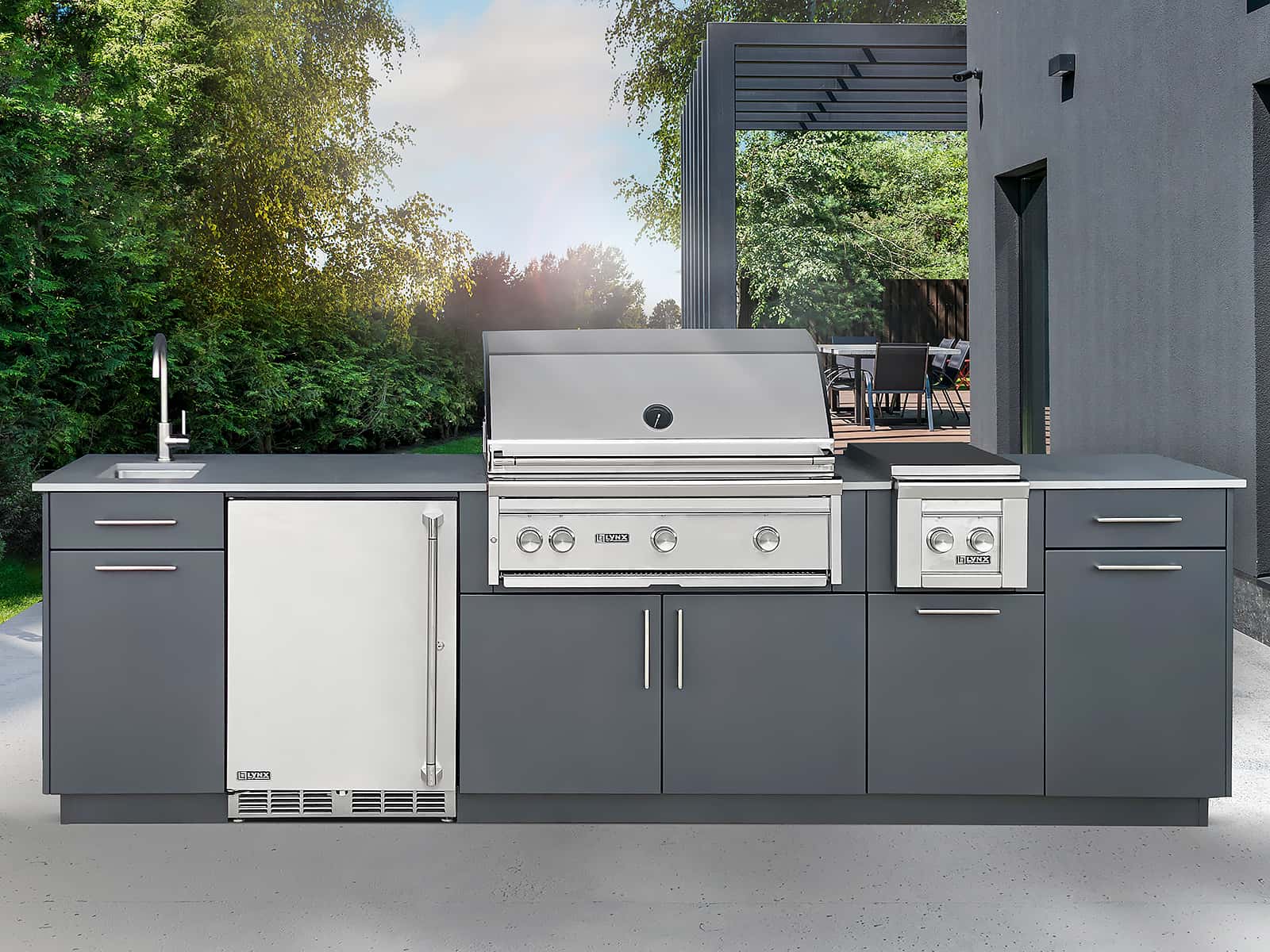 grey cabinetry LYNX grill in backyard outdoor kitchen