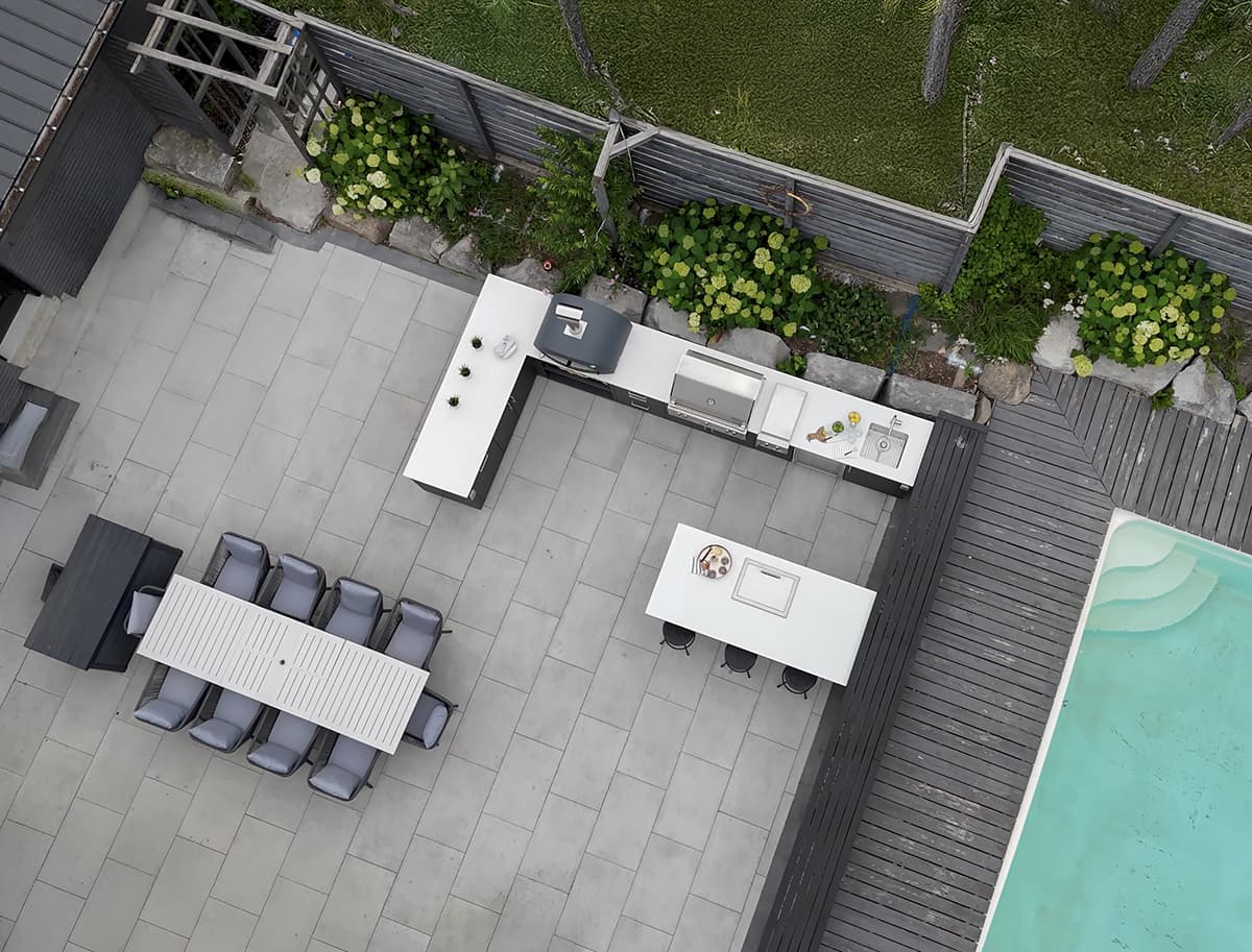 Modern outdoor kitchen with built in Alfresco grill and Alumina cabinetry on a covered terrace
