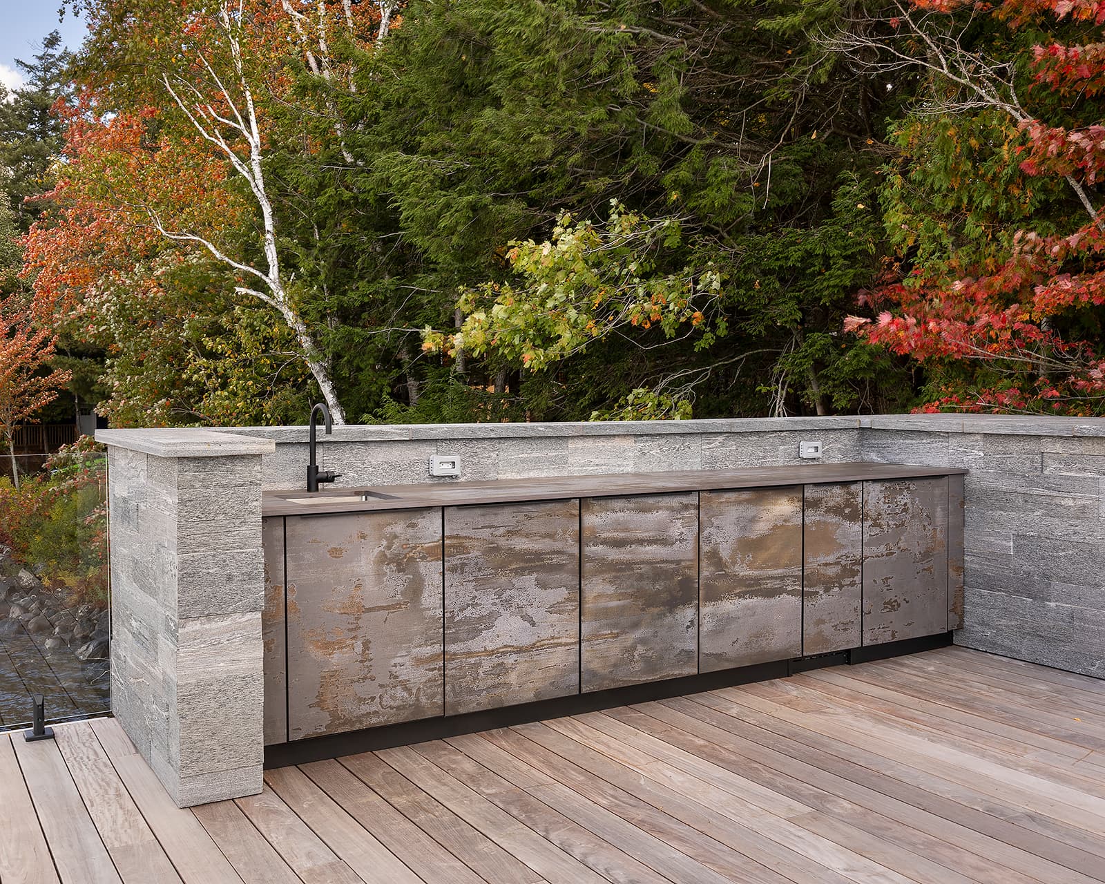 Galley-style outdoor kitchen cabinetry looking toward shoreline.