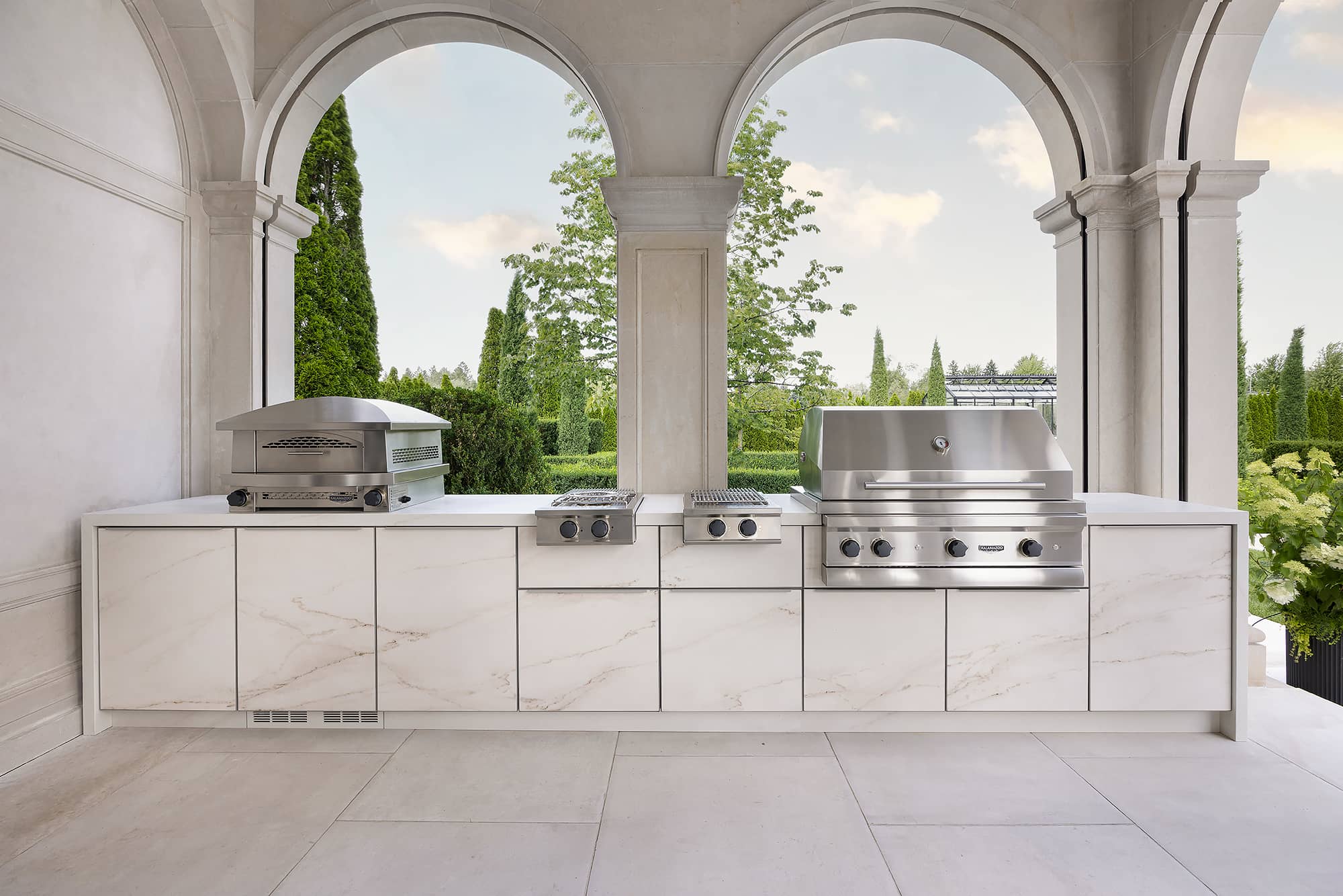 AS cabinet with a Kalamzazoo grill, pizza oven, and side burner