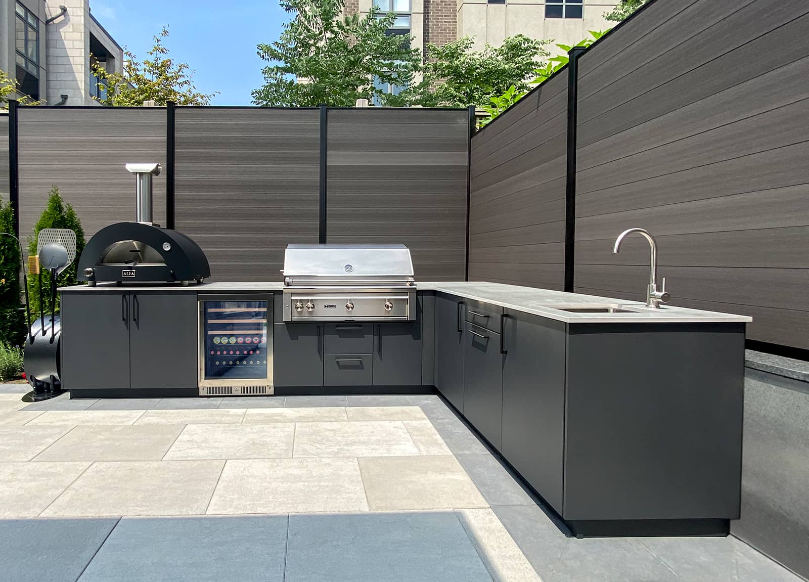 photo of cabinetry, pizza oven, grill, and sink
