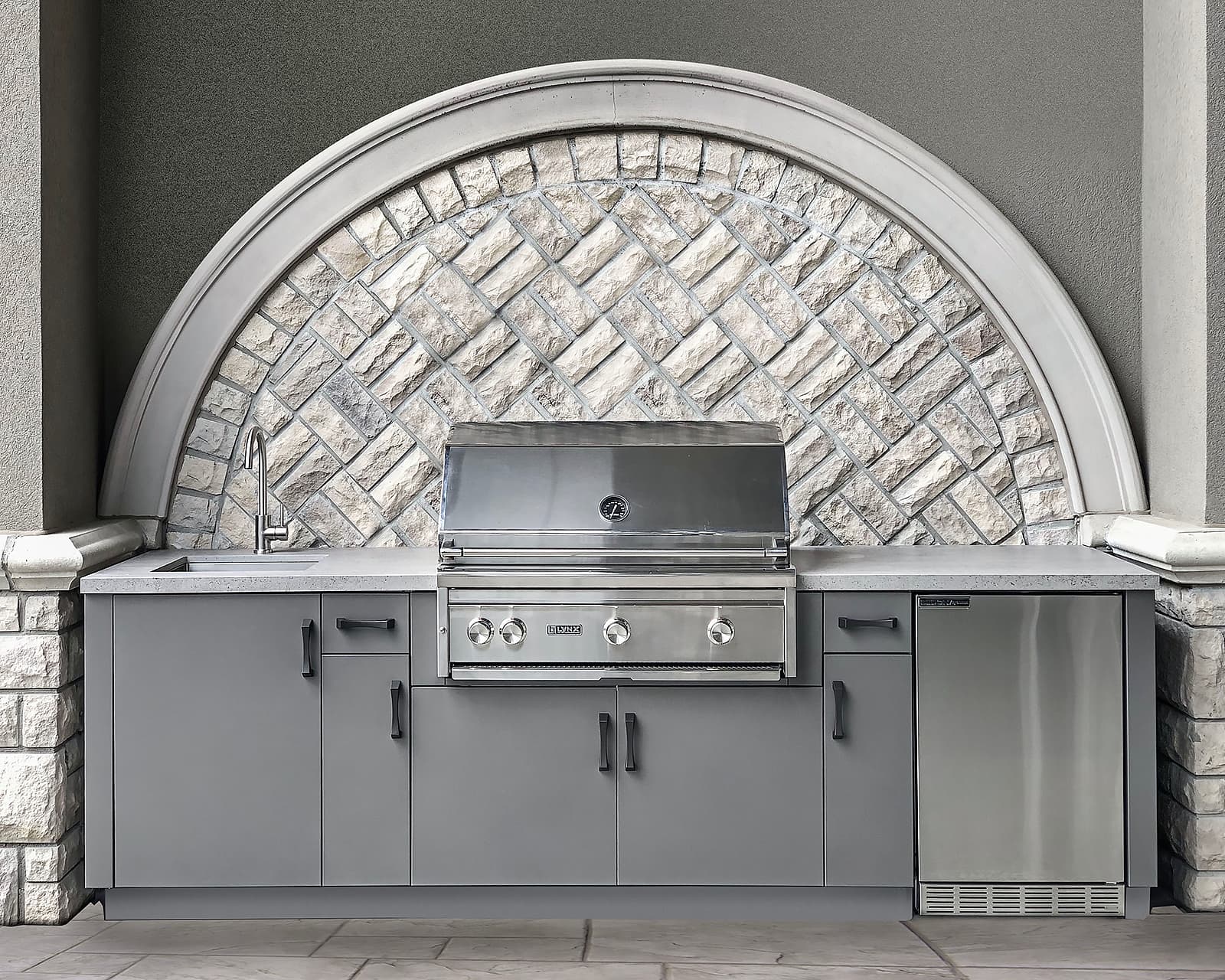 Alumina cabinetry with Lynx grill and arched backdrop