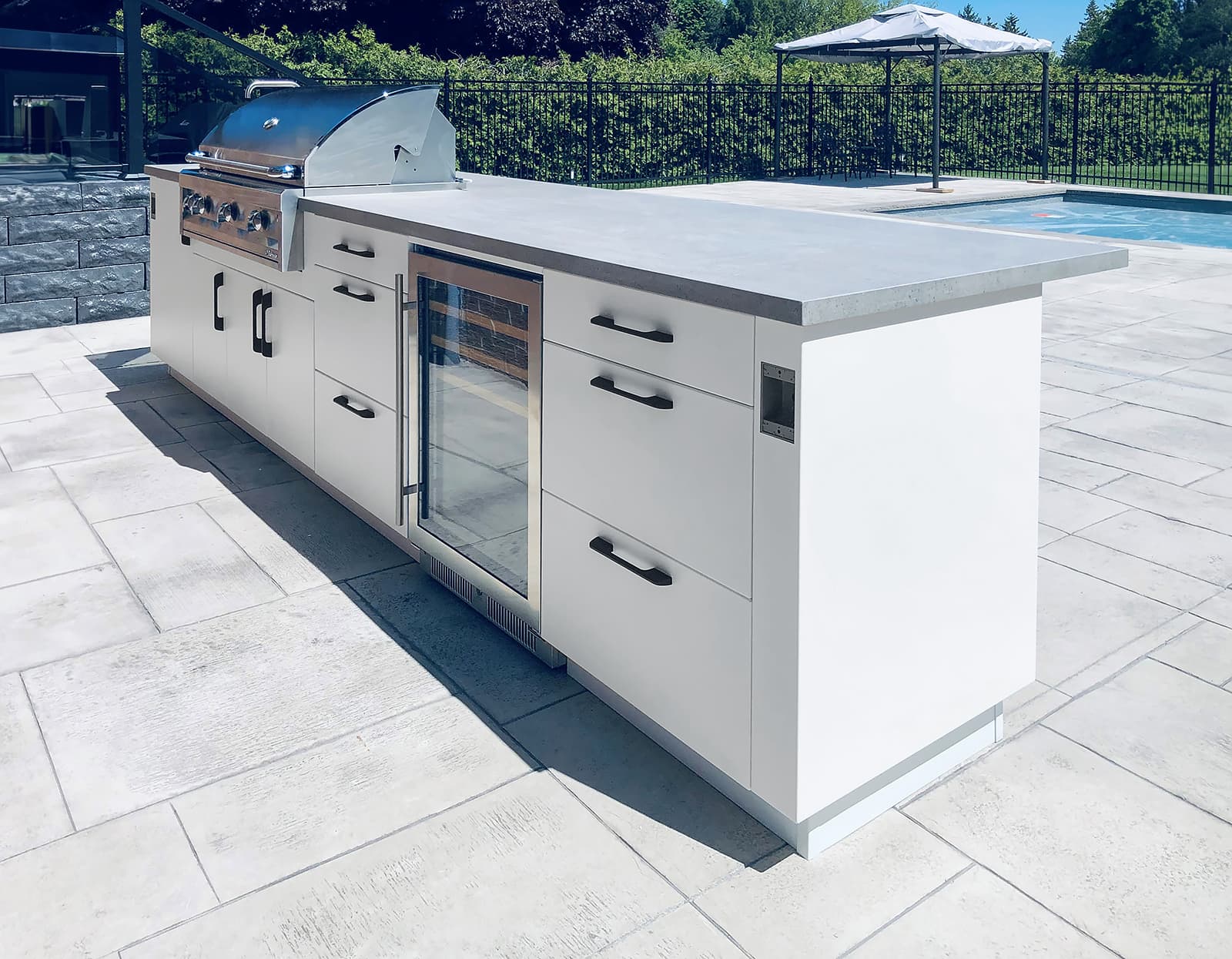 Alumina outdoor cabinetry in white by pool