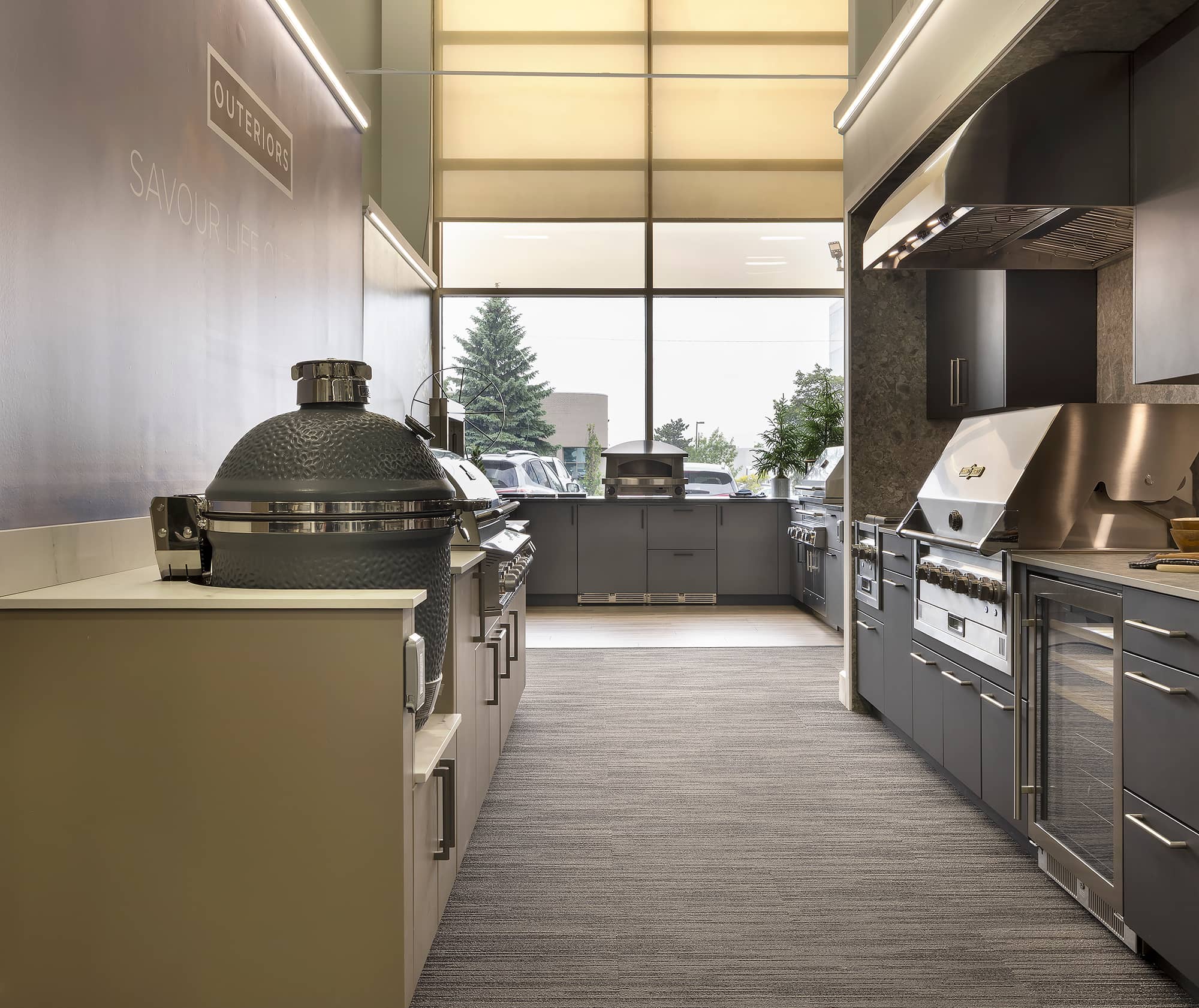 two galley style outdoor kitchen displays facing each other with Blaze Kamado grill and Crown Verity grill