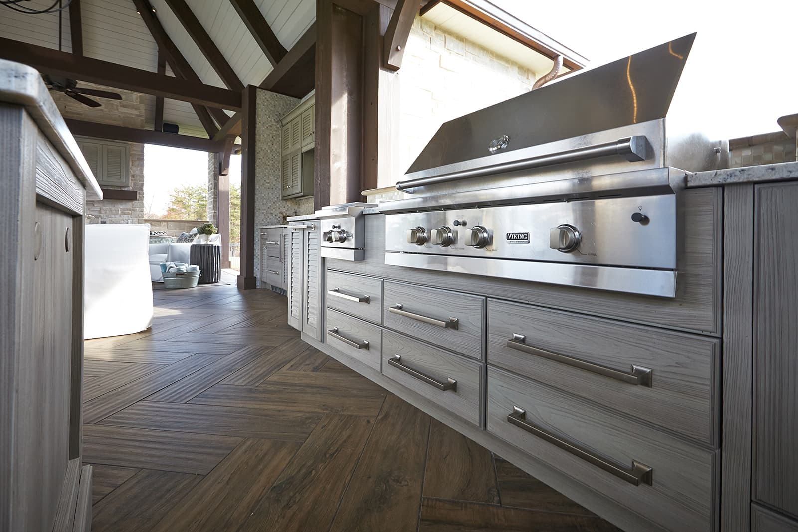 Covered outdoor kitchen with NatureKast cabinetry