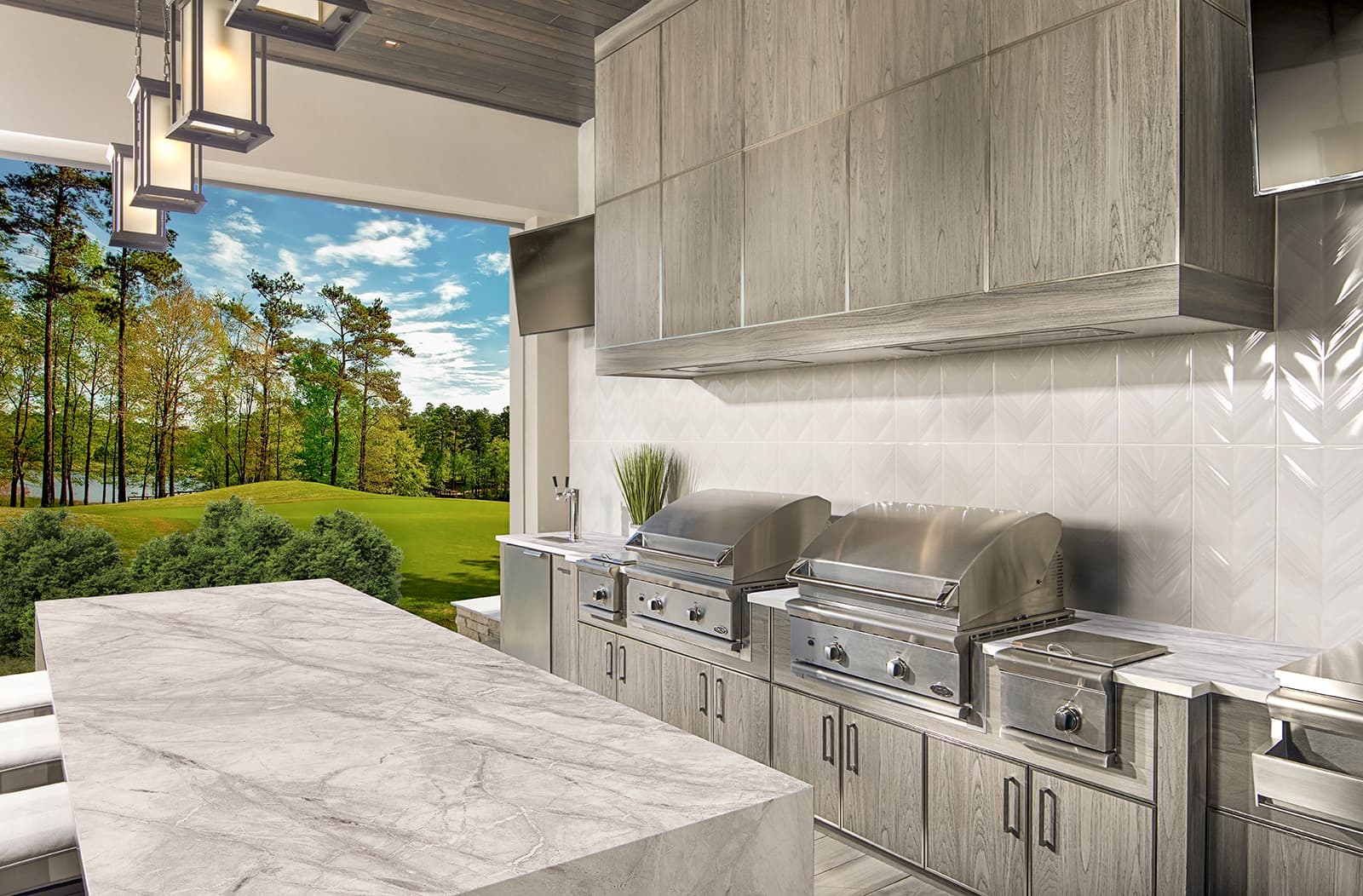Large covered outdoor kitchen with NatureKast cabinetry and two grills with side burners and sink