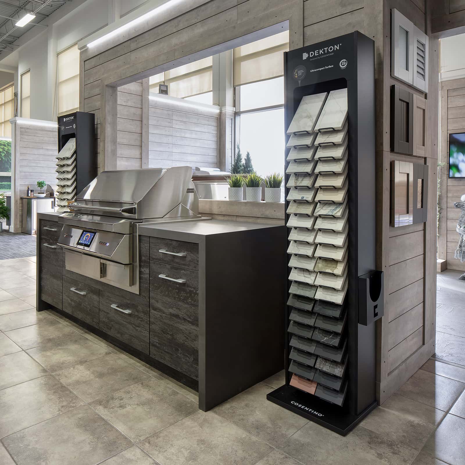 dark brown kitchen cabinetry and grill wit countertop samples at Outeriors showroom