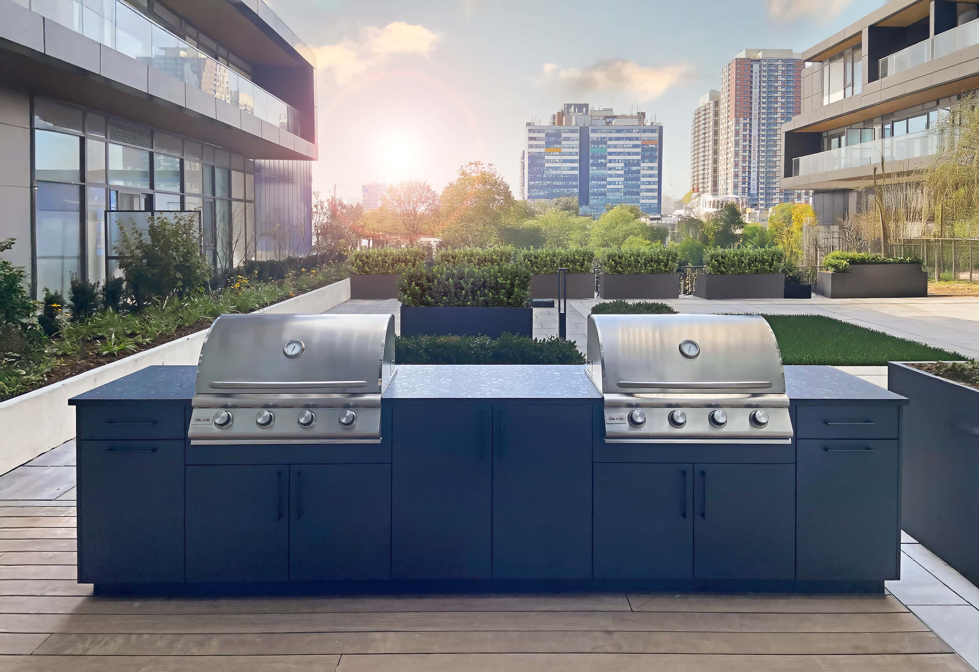 Outdoor kitchen installation in condo amenity space with built-in grills and modern cabinetry