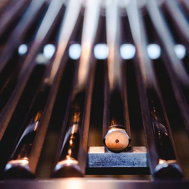 man grilling steak on grill