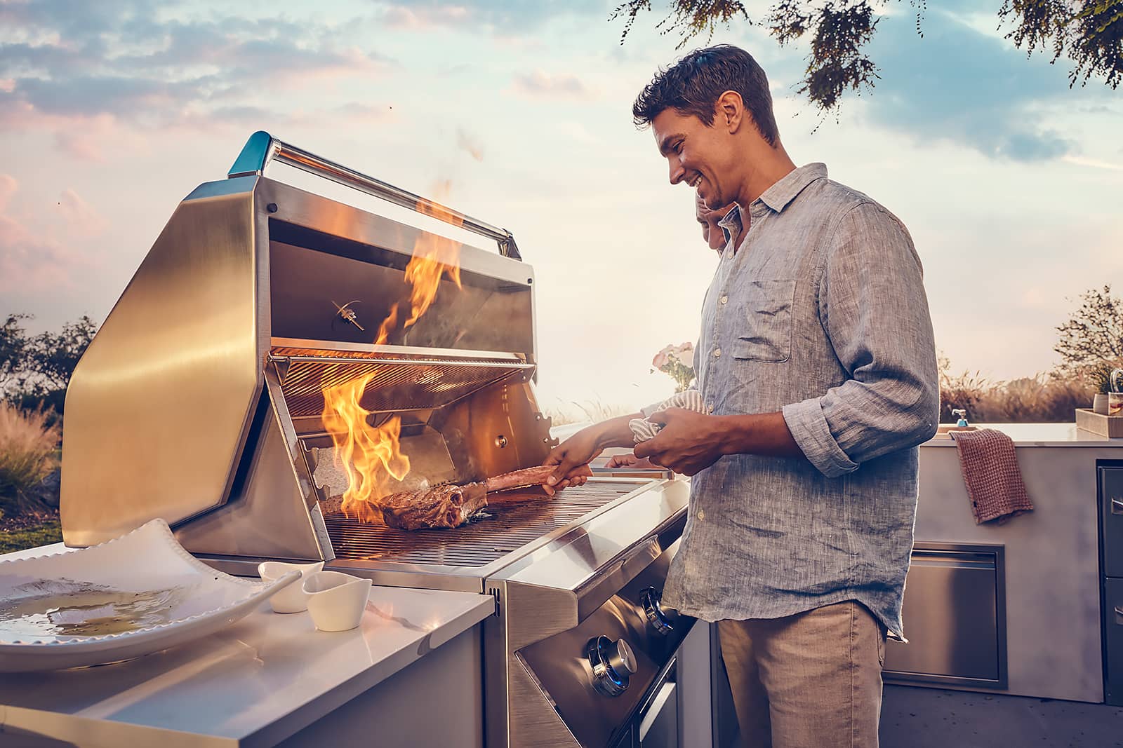 man grilling steak on grill